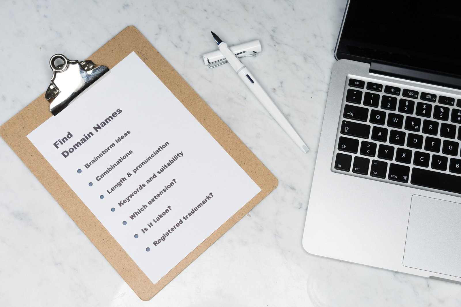 white printer paper beside silver macbook
